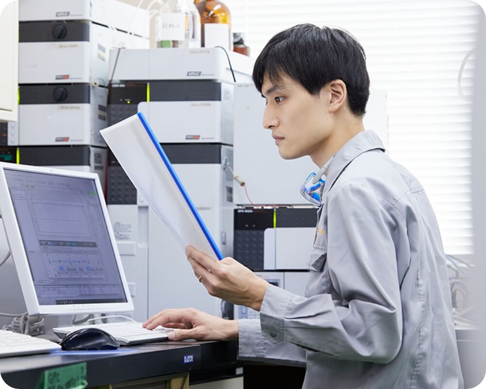 真剣な眼差しで書類とパソコンをにらめっこする社員