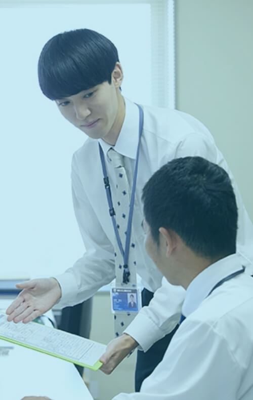 上司に書類を見せる社員